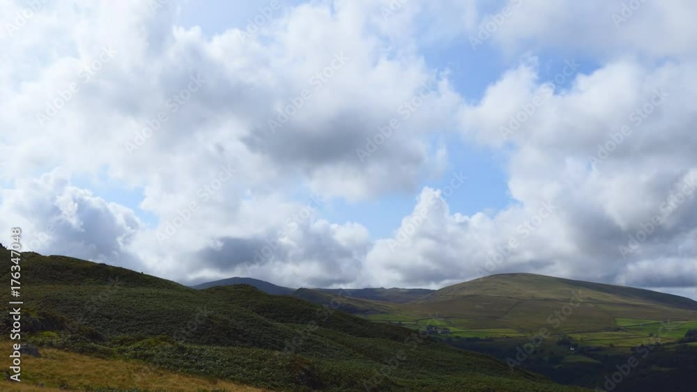White fluffy clouds over the hills. White fluffy clouds over the hills.