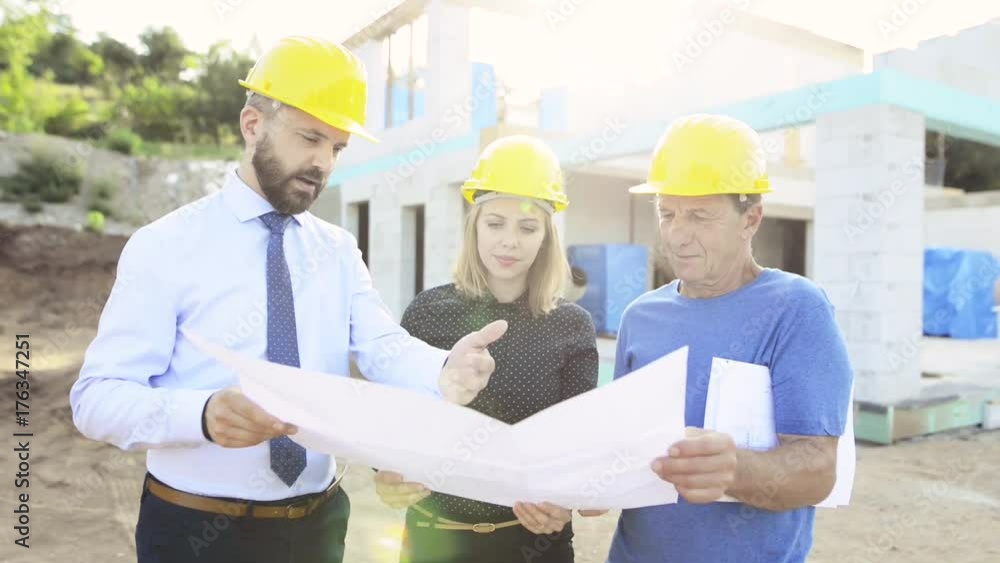 Architects and worker at the construction site. Architects and worker at the construction site.