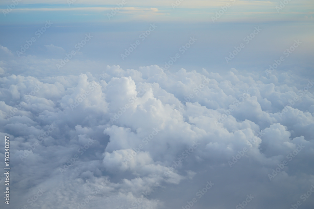 Shades of light blue color sky and amazing white floating cloud view from airplane window Shades of light blue color sky and amazing white floating cloud view from airplane window