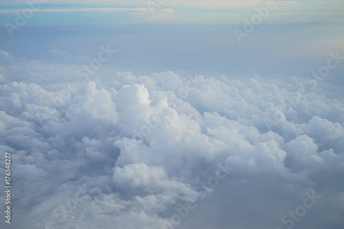 Shades of light blue color sky and amazing white floating cloud view from airplane window