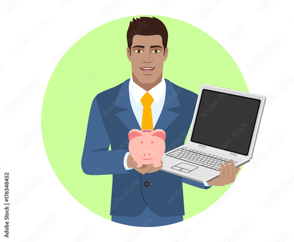 Businessman holding a piggy bank and laptop notebook