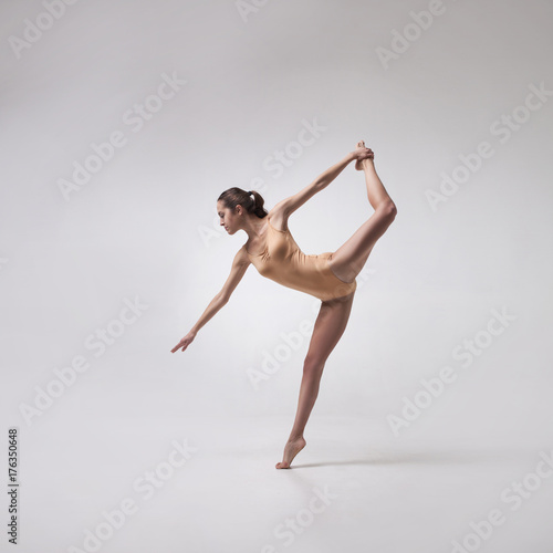 young beautiful ballet dancer in beige swimsuit