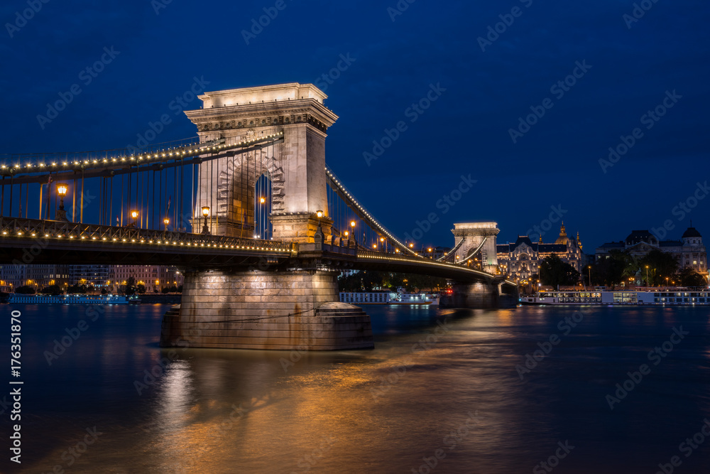 Beautiful night shot of the illuminated Chain Bridge in Budapest across the Danube river in Hungary.
