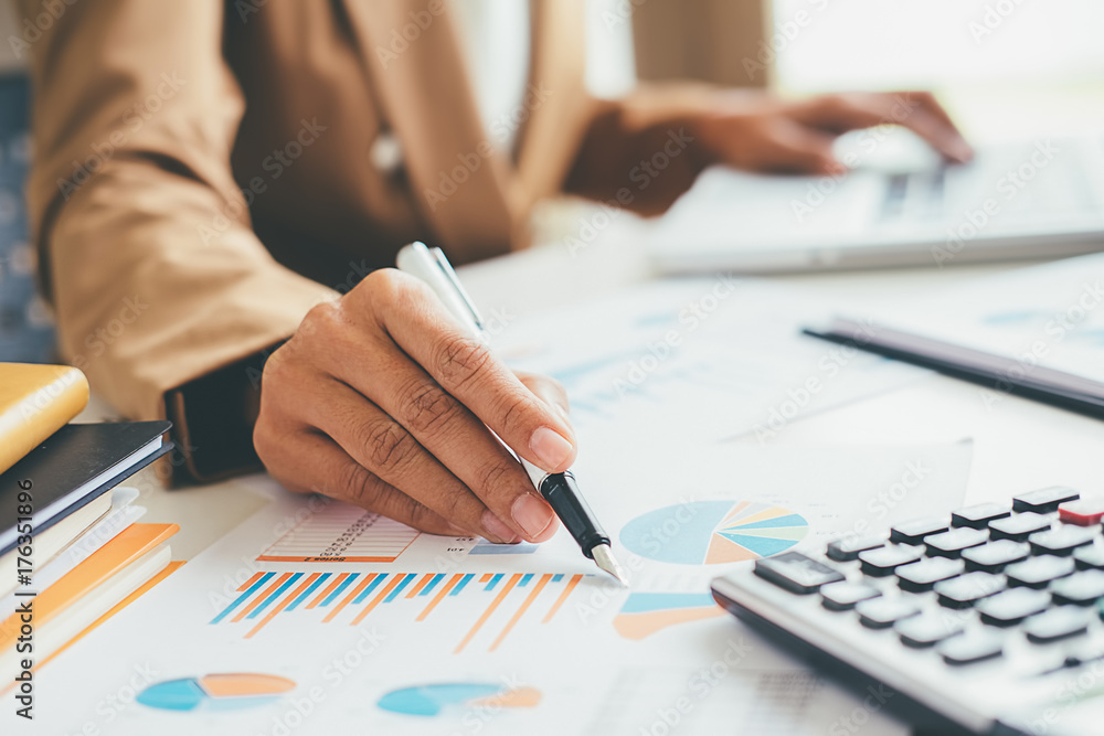 Woman with bills and calculator. Woman using calculator to calculate bills at the table in office. Calculation of costs. Woman with bills and calculator. Woman using calculator to calculate bills at the table in office. Calculation of costs.