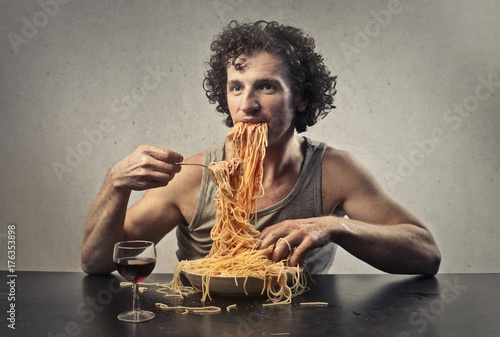 Greedy man eating spaghetti