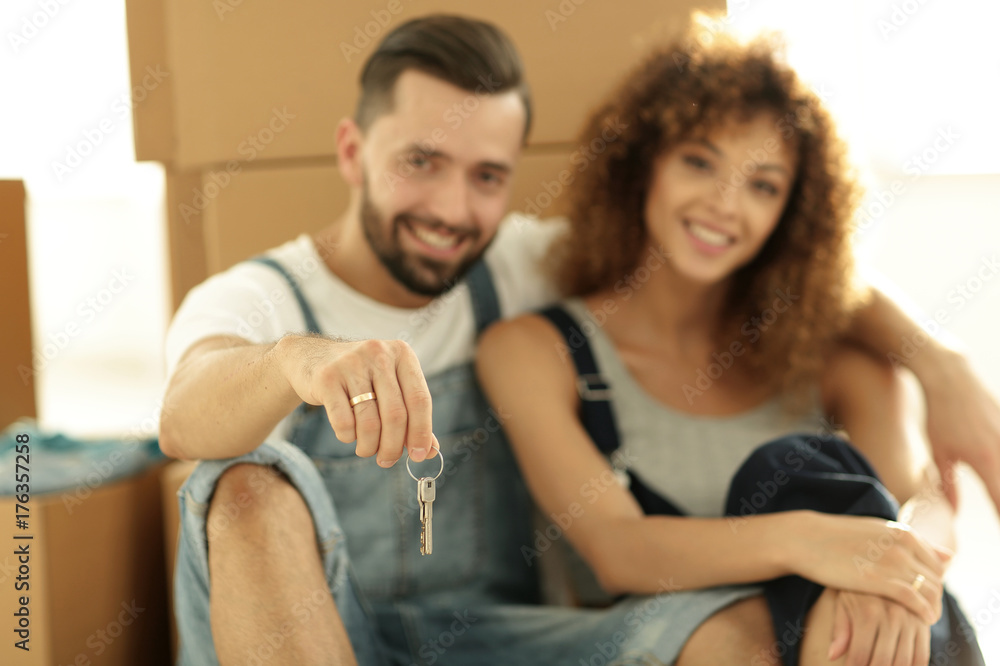 Close-up of a young couple on a background of cardboard boxes Close-up of a young couple on a background of cardboard boxes
