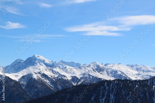 Background of blue sky over snow-capped mountains