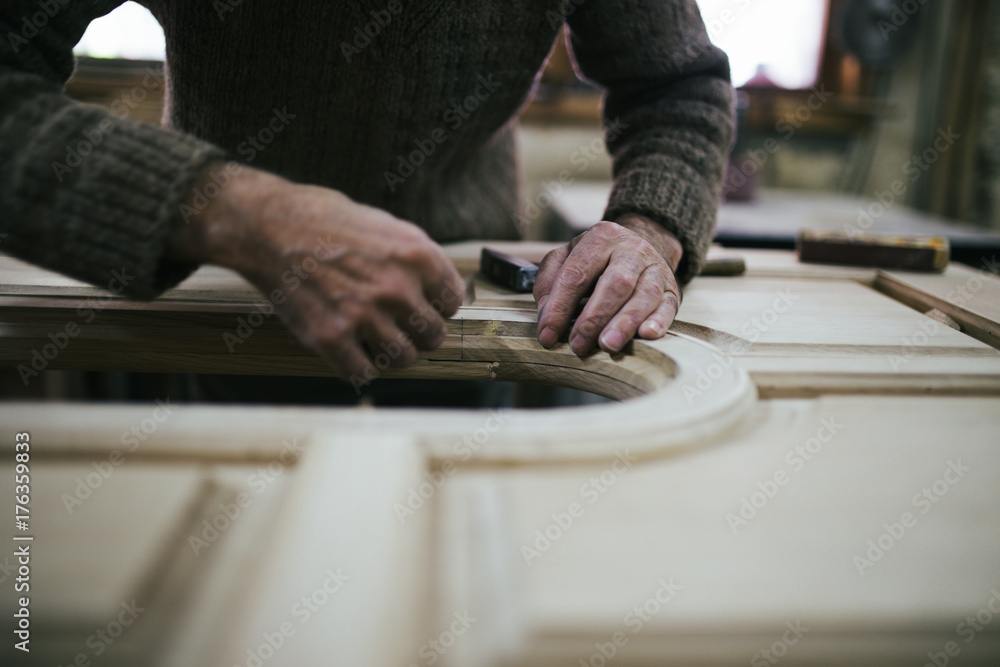 Close up shot of old master carpenter working in his woodwork or workshop Close up shot of old master carpenter working in his woodwork or workshop