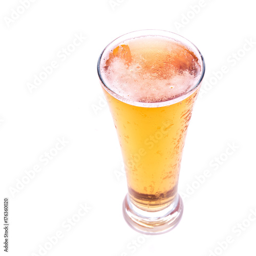 Fresh gold cold and delicious lager beer in glass over white background