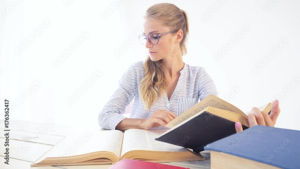 business girl sits in the Office paper folders Secretary reads books business girl sits in the Office paper folders Secretary reads books