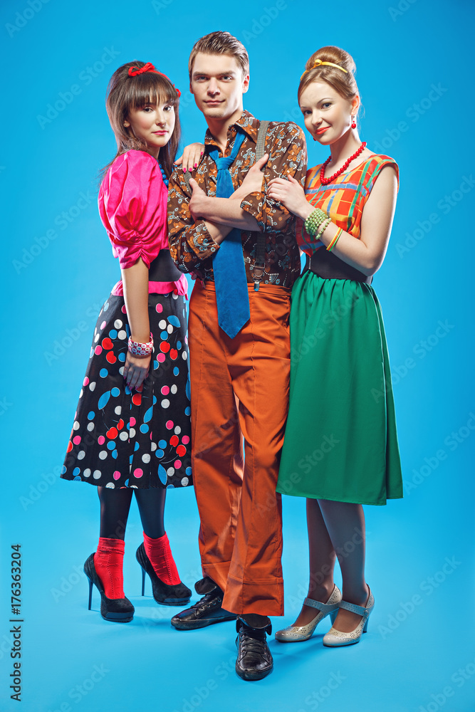 Young people wearing colorful old-fashion clothes in pinup style
