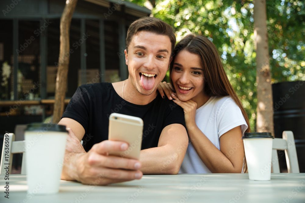 Portrait of a funny young couple taking selfie Portrait of a funny young couple taking selfie