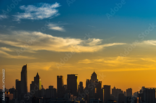 Silhouette skyscraper cityscape view at morning time with business and residential building, Bangkok, Thailand. Golden and blue sky.