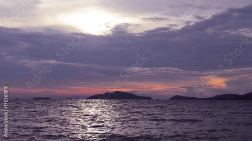 Cloudy rainy sunset above the dark sea waves