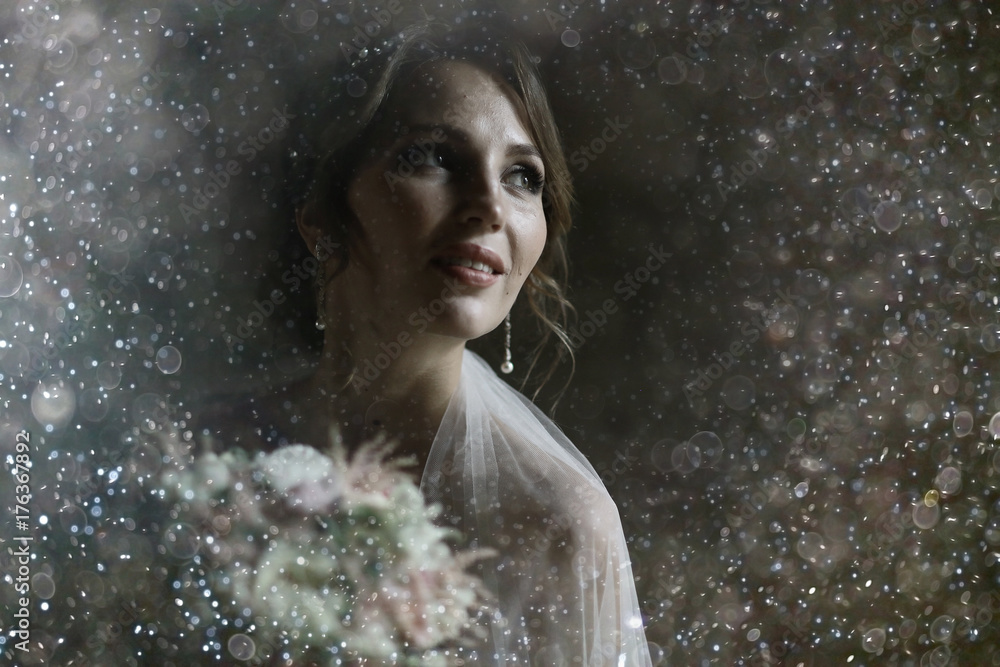 Bride with a bouquet of flowers in a white dress at a wedding