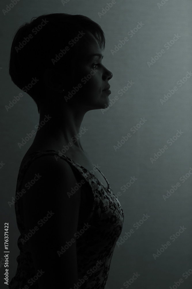 Silhouette of a girl with short hair studio portrait Silhouette of a girl with short hair studio portrait