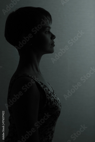 Silhouette of a girl with short hair studio portrait © kichigin19