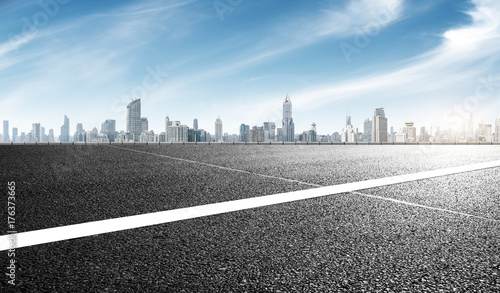 empty asphalt road with cityscape of shanghai in blue sky photo