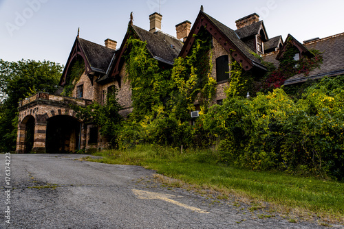 Exterior View at Sunset / Blue Hour with Distressed Asphalt Driveway - Abandoned Tioranda Mansion and Hospital - New York