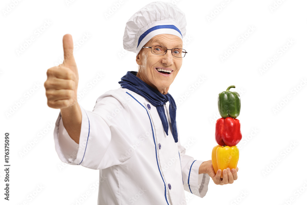 Elderly chef with peppers making a thumb up gesture Elderly chef with peppers making a thumb up gesture