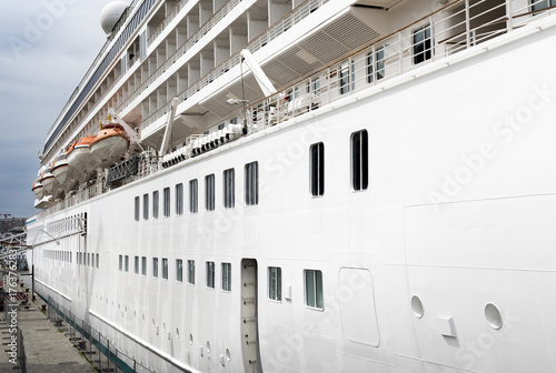Right side of cruise ship moored to a berth. View at starboard side of docked liner in port