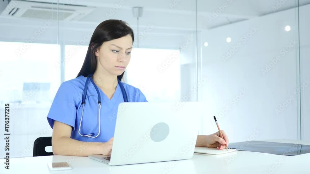 Doctor Writing Medical Reports of Patient, Sitting in Front Doctor Writing Medical Reports of Patient, Sitting in Front