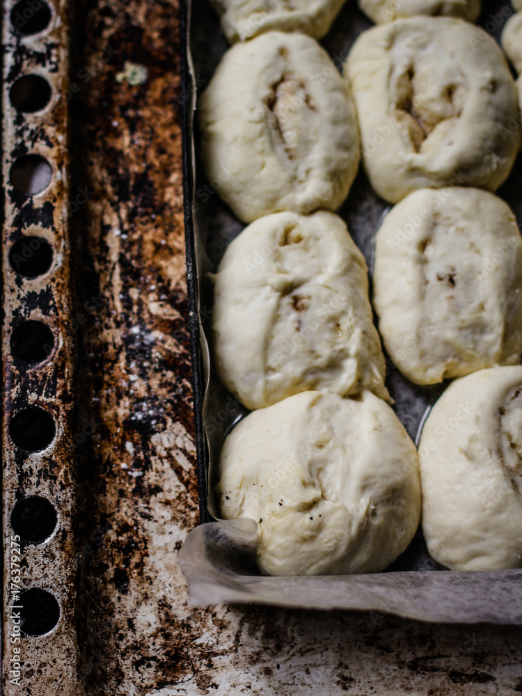 baking rolls with cinnamon - raw dough on a baking tray baking rolls with cinnamon - raw dough on a baking tray