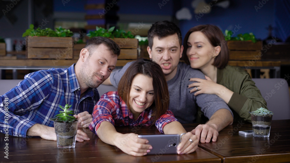 Group of friends taking selfie in restaurant Group of friends taking selfie in restaurant