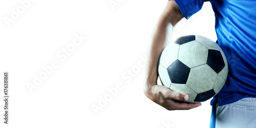 Soccer player holds a soccer ball on a professional stadium. Isolated football player in unbranded sport uniform on a white background.
