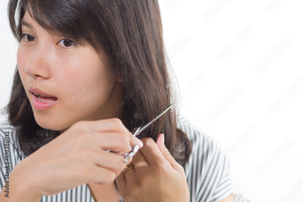 woman cutting her hair on white background woman cutting her hair on white background