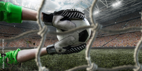 Fényképezés Soccer goalkeeper catches a ball on big professional football arena