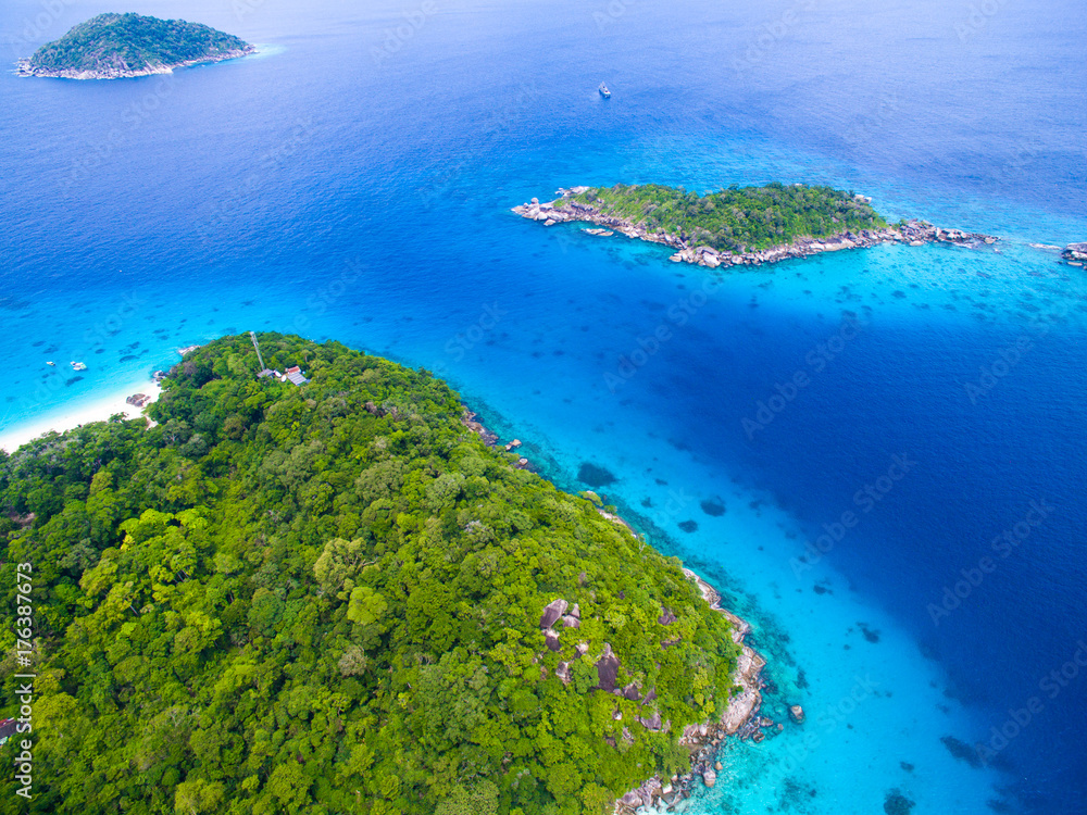 Aerial view of isolated tropical island with blue clear water and granite stones. Top view of coral reef at Similan Islands, Thailand.