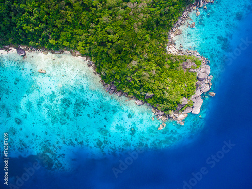 Aerial view of isolated tropical island with blue clear water and granite stones. Top view of coral reef at Similan Islands, Thailand.