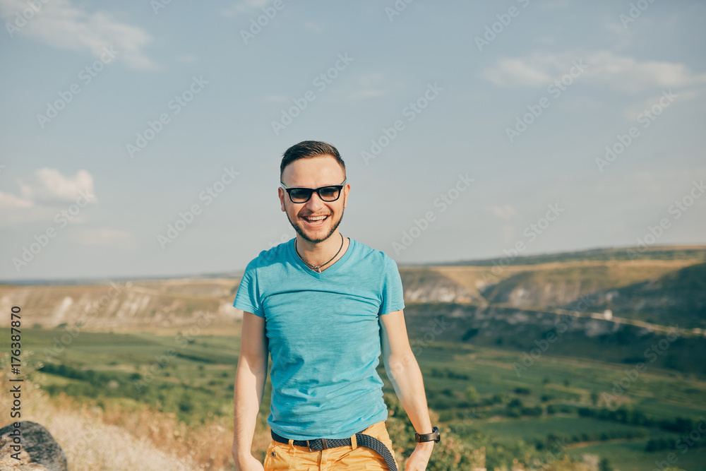 Naklejka premium Young man smiling and enjoying sunny summer day