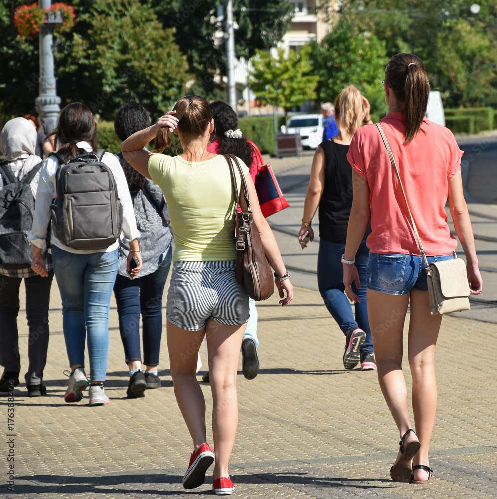 Obraz premium Young women are walking on the street in the city