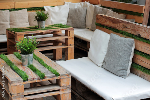 The tables and sofas of wooden pallet and grass photo