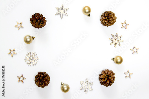 Christmas holidays background. Christmas decoration, fir and golden ball on white background with copy space.