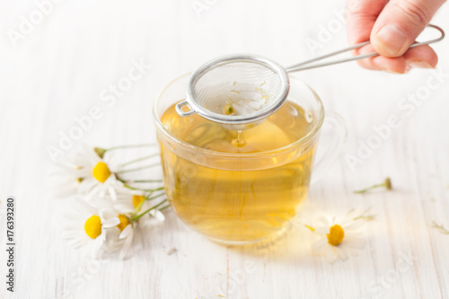 Percolation of decoction of chamomile flowers through a sieve