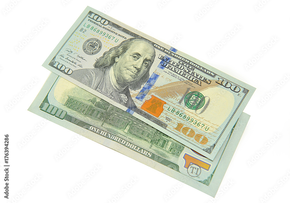 Two denominations of one hundred dollars on white . Two denominations of one hundred dollars on white .