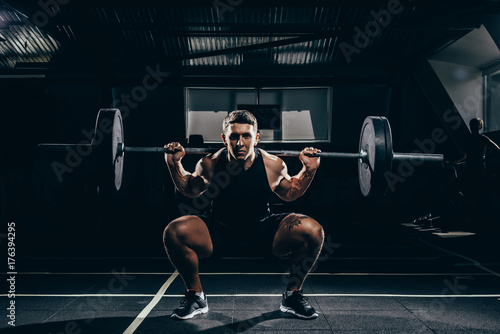 sportsman lifting a barbell photo