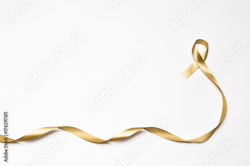 childhood ribbon, gold ribbon as symbol of childhood cancer awareness isolated on white background