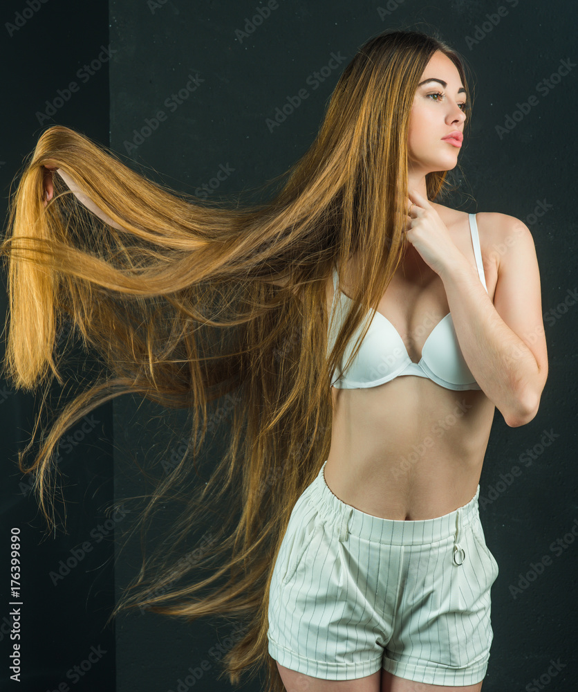Girl has no makeup and healthy hair on black background. Girl has no makeup and healthy hair on black background.