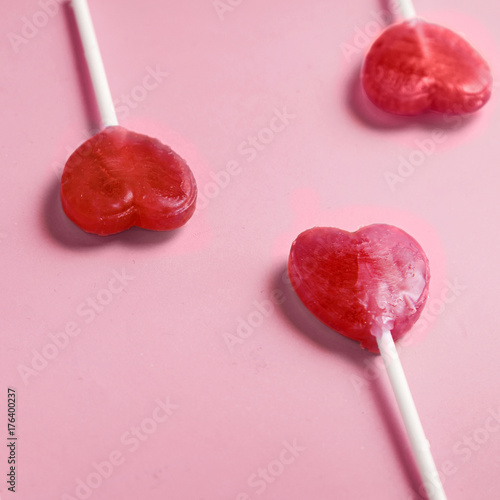 Valentine's day heart shape lollipop candy on pastel pink paper background