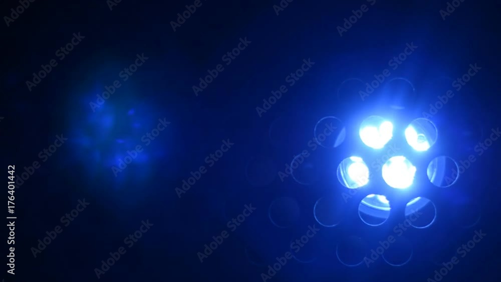 Movement of the light of the blue lantern on a dark perforated background Movement of the light of the blue lantern on a dark perforated background