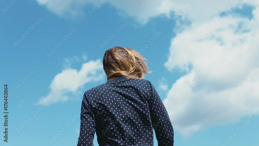 Beautiful young woman girl blue shirt sky clouds back view portrait nowhere wind blowing long hair creative shoot windy weather turning around smiling happy pretty lady summer sunny day fun cheerful Beautiful young woman girl blue shirt sky clouds back view portrait nowhere wind blowing long hair creative shoot windy weather turning around smiling happy pretty lady summer sunny day fun cheerful