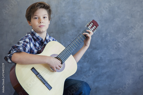 Teen boy with acustic guitar