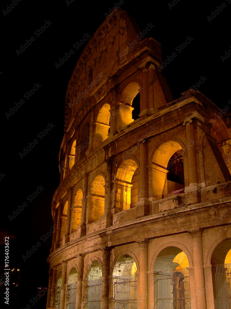 Portion of the Roman Forum also known as the Coliseum in beautiful Rome at night .