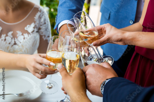 Hands holding glasses and toasting, happy festive moment, luxury celebration concept.