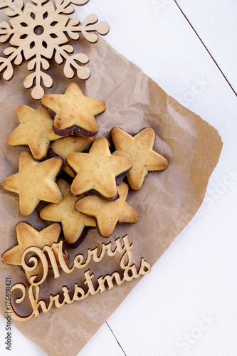 cookies on kraft paper with wood snowflake and an inscription