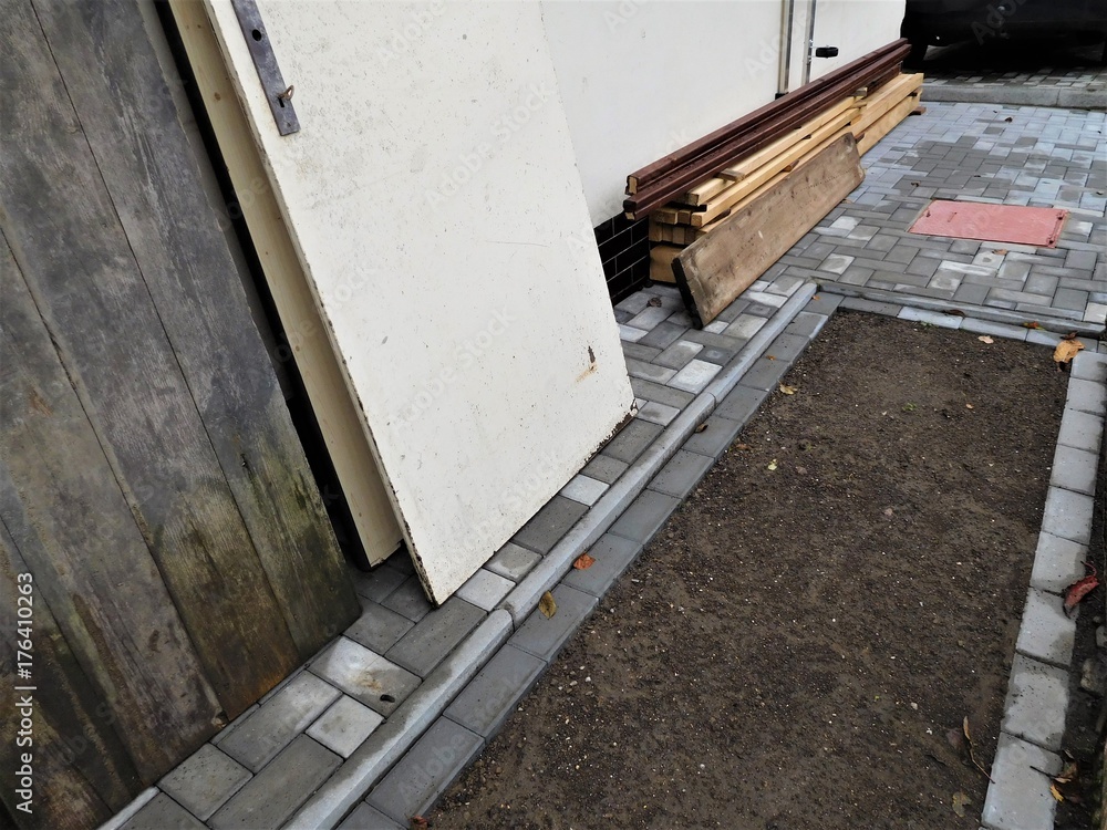 The building new sidewalk and some boards for it The building new sidewalk and some boards for it